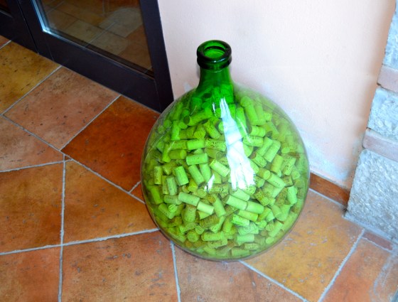 Old glass bottle full of wine corks