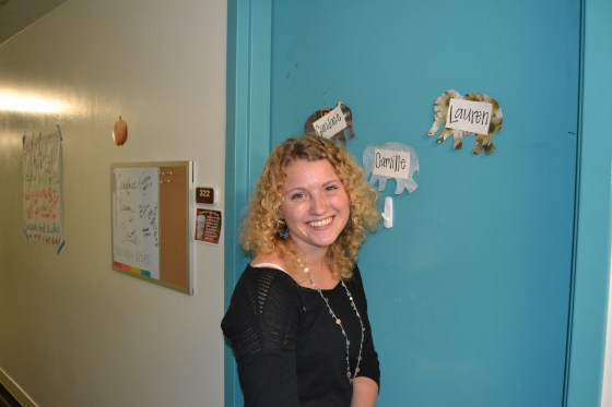Lauren pauses in front of her freshman dorm room. 