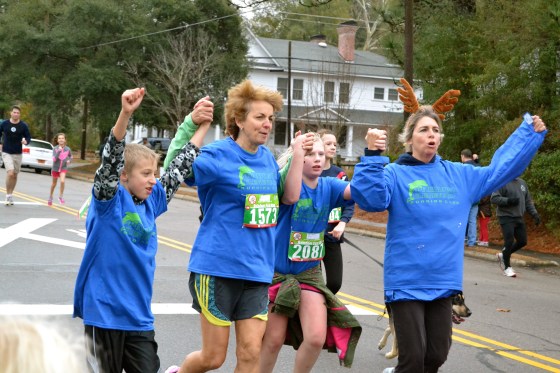 Ms. Harms finishes the race with some PES students